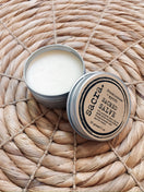 Open tin of Frankincense & Myrrh Sacred Salve, handcrafted with Premium Omani frankincense, myrrh, beeswax, and nourishing botanical oils for natural skin care.