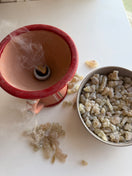 Premium Omani Hojari Boswellia sacra frankincense resin burning on charcoal, releasing its fresh, citrus-like aroma as a natural incense.