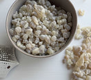 Premium Omani Hojari Boswellia sacra frankincense resin displayed in a bowl, sustainably harvested in the Dhofar region of Oman.